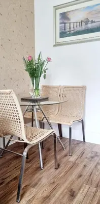 a table with two chairs and a vase of flowers at Churchview in Townhill