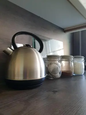 a tea kettle sitting on a counter next to jars at Churchview in Townhill