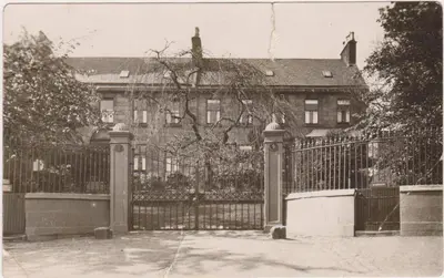a black and white photo of a fence with a house at Ashtree House Hotel, Glasgow Airport & Paisley in Paisley
