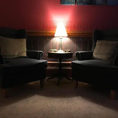 a room with two chairs and a table with a lamp at Ashtree House Hotel, Glasgow Airport & Paisley in Paisley