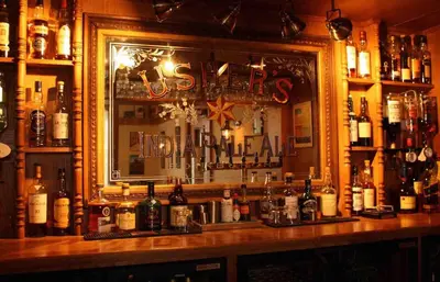 a bar filled with lots of bottles of alcohol at The Crags Hotel in Callander