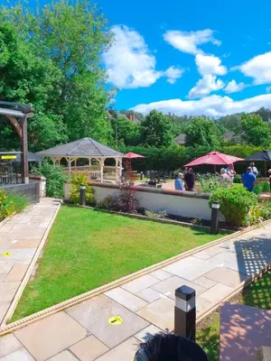 a garden with people sitting on a patio at Number 10 Hotel in Glasgow