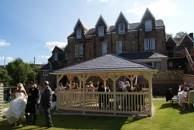 a group of people in a gazebo in front of a building at Number 10 Hotel in Glasgow
