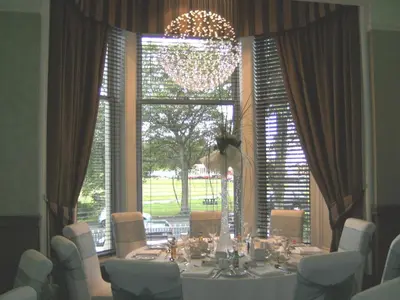 a dining room with a table and a large window at Number 10 Hotel in Glasgow