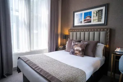 a bedroom with a bed and a window at Number 10 Hotel in Glasgow