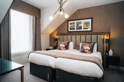 a bedroom with a large bed and a window at Number 10 Hotel in Glasgow