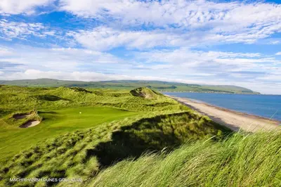 a golf course with a sandy beach and the ocean at The Ugadale Hotel in Campbeltown