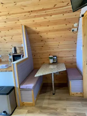 a sauna with a table and bench in a cabin at Kersebrock Kabins in Falkirk