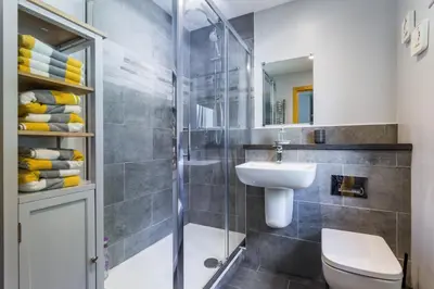a bathroom with a shower and a toilet and a sink at Oakbank Farm in Lamlash