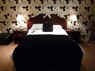a black bag sitting on a bed in a bedroom at The Park Hotel in Dunoon