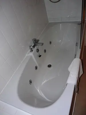 a white bath tub with a faucet in a bathroom at The Park Hotel in Dunoon