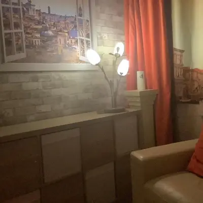 a room with a table with a lamp and a couch at Nethermains House in Kilwinning