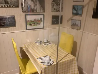 a table with yellow chairs and a yellow table cloth at Nethermains House in Kilwinning