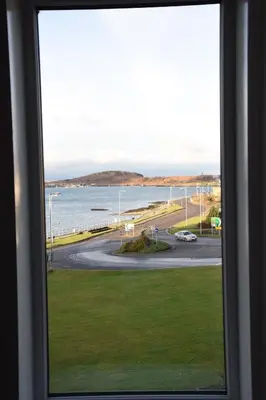 a view of the ocean from a window at Corran House Guest House in Oban