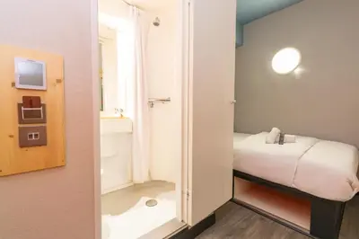 a small room with a bed and a bathroom at easyHotel Glasgow City in Glasgow