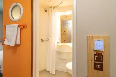 a bathroom with a white toilet and a sink at easyHotel Glasgow City in Glasgow