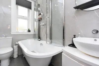 a white bathroom with a sink and a toilet at Crewe Apartment - Stylish 2 bedroom apt, Garden, Free parking, Edin City in Edinburgh