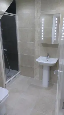 a bathroom with a sink and a shower and a toilet at Doonbank Cottage Bothy in Ayr