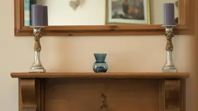 a wooden shelf with a vase and two candles on it at Pippin, Tranquil Scottish Cottage with Hot Tub in Airdrie
