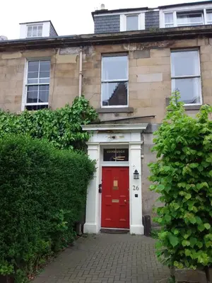a red door on a house with a red door at IVY- Braveheart Guest House in Edinburgh