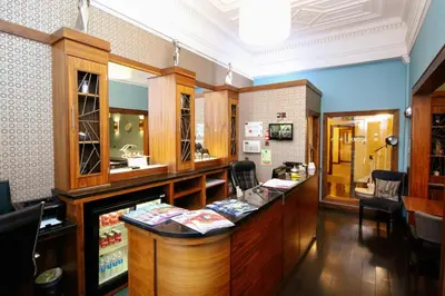 a restaurant with a counter in a room at Acorn Hotel in Glasgow