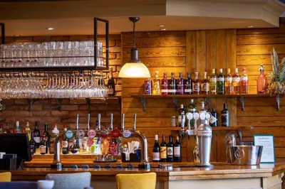 a bar with a lot of bottles of alcohol at The Waverley Hotel in Callander