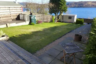 a backyard with a view of the water at Tigh Na Mara in Furnace