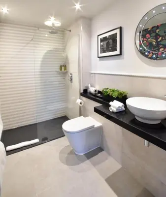 a bathroom with a toilet and a sink and a shower at The Rutland Hotel & Apartments in Edinburgh