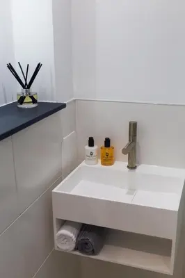 a bathroom with a white sink in a white bathroom at Gillespie House in Edinburgh