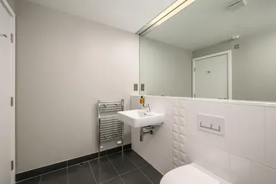 a bathroom with a sink and a toilet and a mirror at Destiny Scotland -The Malt House Apartments in Edinburgh