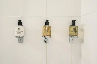 a group of bottles hanging on a wall at Destiny Scotland -The Malt House Apartments in Edinburgh