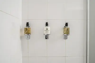 a bathroom with four lights hanging from the wall at Destiny Scotland -The Malt House Apartments in Edinburgh