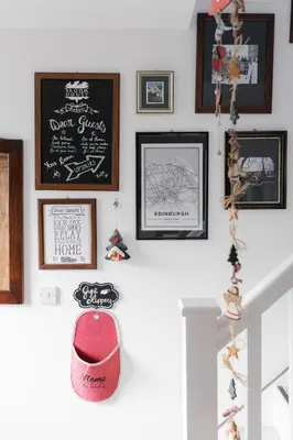 a room with pictures on the wall and a red hat at BroomHouse HomeStay in Edinburgh
