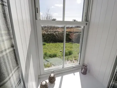a window in a room with a view of a yard at Corrafeckloch Forest Cottages in Bargrennan