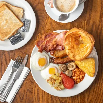 a plate of breakfast food with eggs bacon and toast at Toby Carvery Edinburgh West by Innkeeper's Collection in Edinburgh