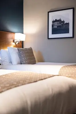a hotel room with two beds and a picture on the wall at Toby Carvery Strathclyde, M74 J6 by Innkeeper's Collection in Motherwell