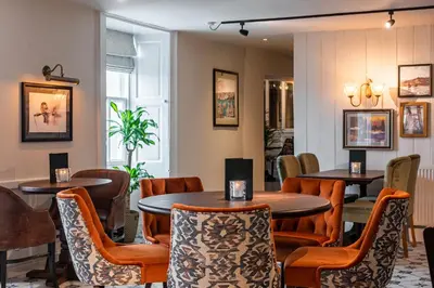 a restaurant with tables and chairs in a room at The Hawes Inn by Innkeeper's Collection in Queensferry