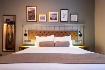 a bedroom with a large white bed with two pillows at The Hawes Inn by Innkeeper's Collection in Queensferry