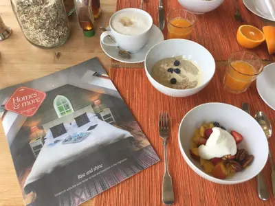 a table with two bowls of food and a magazine at Winterton in Lochgilphead