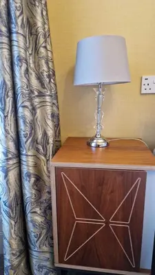 a table with a lamp on top of a dresser at The Abbotsford in Callander
