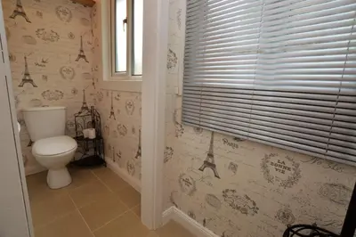 a bathroom with a toilet and a window at Cedar Cottage in Dunoon