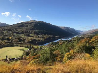 a view of a mountain with a river at Woodside Logcabin Ardoch Lodge in Strathyre