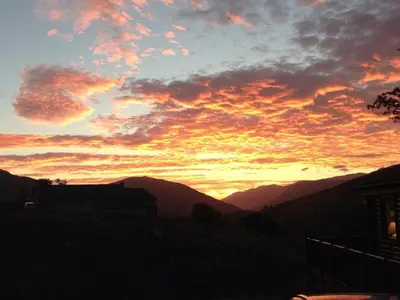 a sunset with mountains in the background at Balquhidder Braes Holiday Park Lodges, mostly with Hot Tubs and pet friendly, EV facilities in Lochearnhead