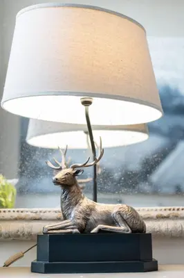a statue of a deer sitting next to a lamp at Drylaw House, Grade A Listed Mansion near City Centre in Edinburgh