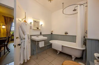 a bathroom with a bath tub and a sink at Barcaldine Castle in Oban