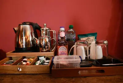 a wooden tray with a tea kettle and other items at Barcaldine Castle in Oban