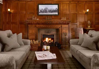 a living room with two couches and a fireplace at Wyndham Duchally Country Estate in Auchterarder