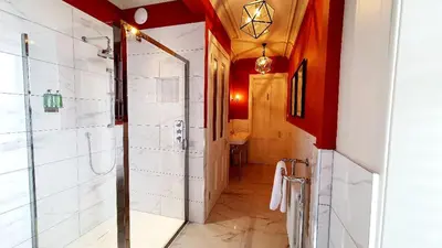 a bathroom with a walk in shower and a toilet at Dungallan Country House in Oban