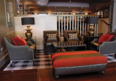 a room with chairs and a bed and a table at Eglinton Arms Hotel, BW Premier Collection in East Kilbride