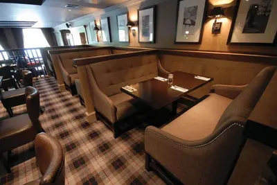 a restaurant with chairs and a table and a bar at Eglinton Arms Hotel, BW Premier Collection in East Kilbride